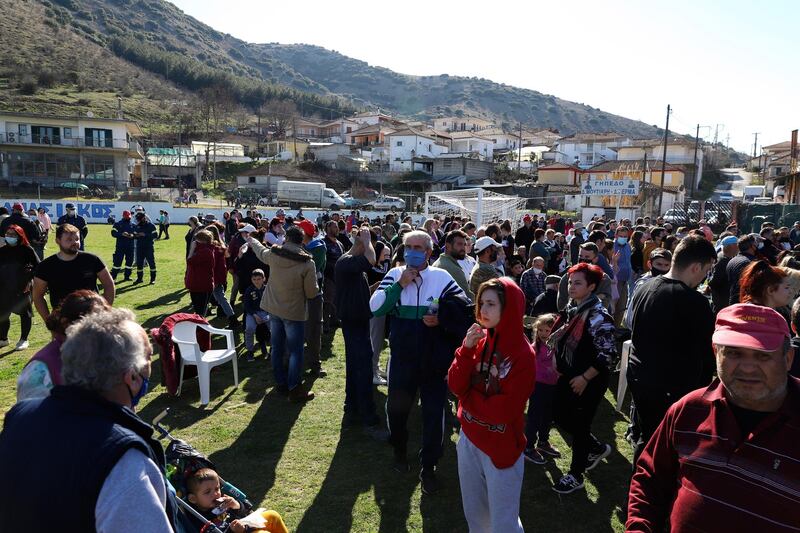 Local residents gather at a soccer field after the earthquake in Damasi. AP Photo