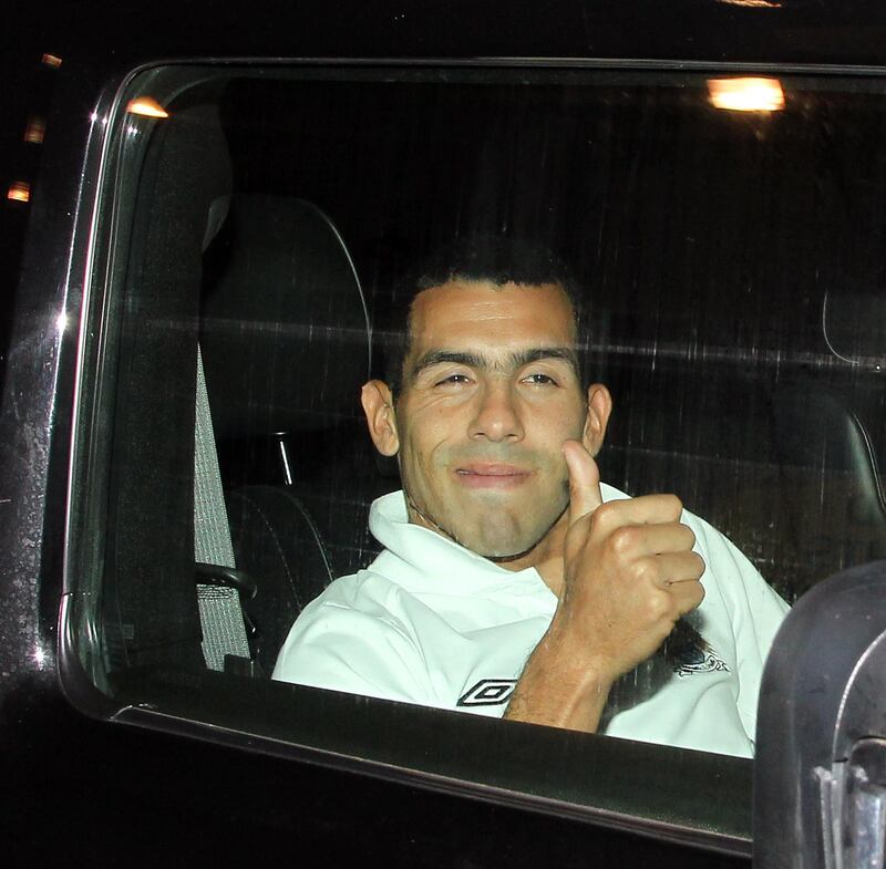 Thums up from Tevez.......Carlos Tevez is given a police escort in his Hummer H2 from Manchester Airport all the way back to his Cheshire mansion at 2.00am on Wednesday morning after the Manchester City returned from their Champions League trip to Munich.