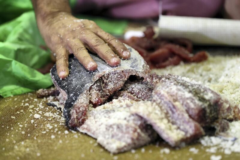 Dibba, United Arab Emirates - June 26, 2019: Fish is salted. Al Hosn fish salting festival. Wednesday the 26th of June 2019. Dibba. Chris Whiteoak / The National