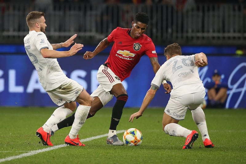 Marcus Rashford tries to get past two Leeds United players. Getty