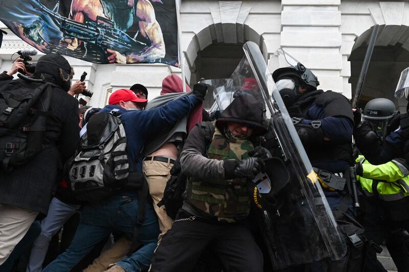 Riot police push back a crowd of rioters at the Capitol building. AFP