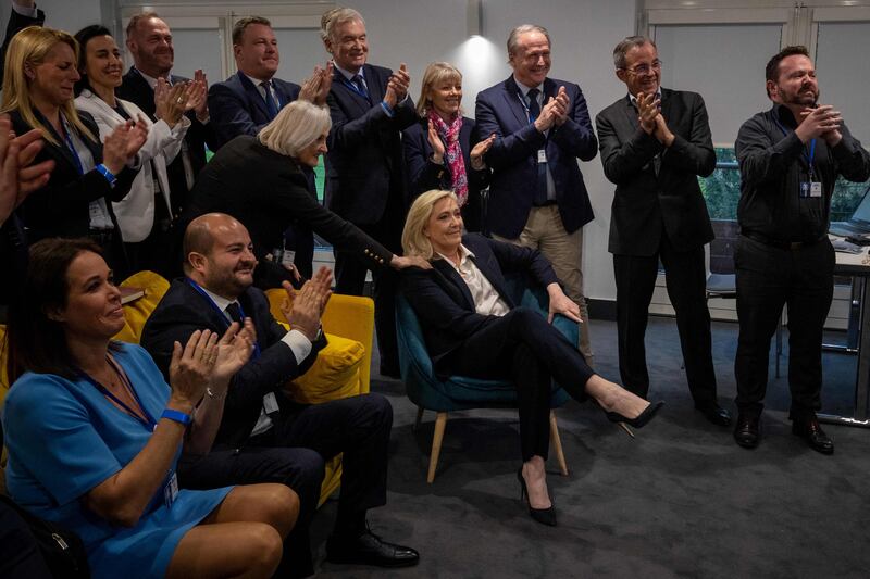 Marine Le Pen, centre, of the French far-right party Rassemblement National, and supporters after the first round of voting. AFP