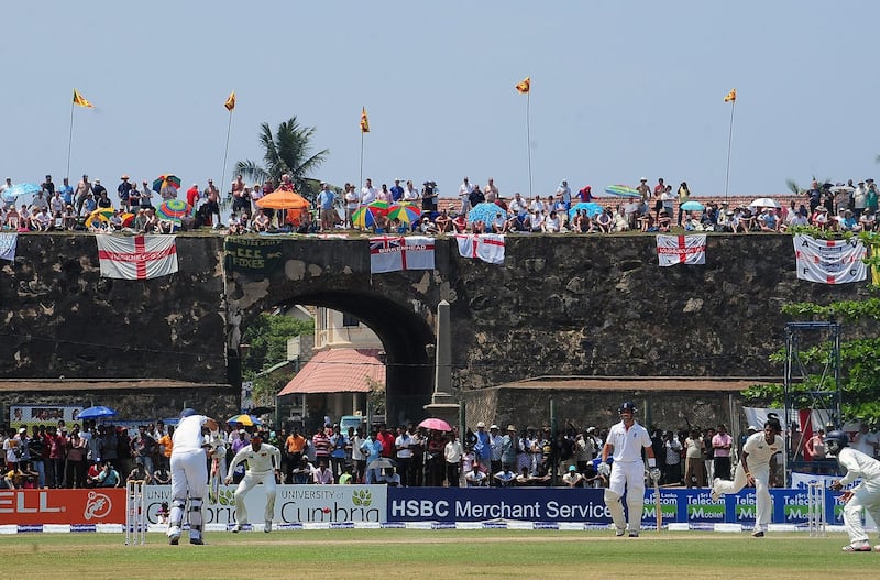 (FILES) In this file photo taken on March 27, 2012 England cricket team fans watch the second day of the opening Test match between Sri Lanka and England from the top of the 17th century Dutch fort overlooking Galle Stadium in Galle. Sri Lanka's picturesque Galle cricket stadium could be demolished because its pavilion stand violated heritage laws protecting a 17th century Dutch fort, the government said July 20, 2018.
 / AFP / Lakruwan WANNIARACHCHI
