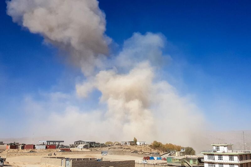Smoke rises from the site of a car bomb attack that targeted an Afghan police headquarters in Feroz Kho, the capital of Ghor Province on October 18, 2020. A car bomb on October 18 targeting an Afghan police headquarters in the western province of Ghor killed at least 12 civilians and wounded more than 100, officials said. / AFP / -
