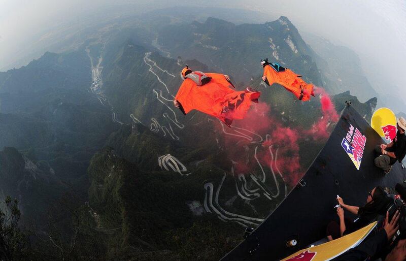 Wingsuit jumpers shown after their leap during the wingsuit flying competition over China's Tianmen Mountain on Sunday in Hunan Province. AFP Photo