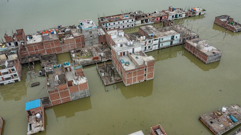Floodwaters surround houses on the banks of the river Ganges, after heavy monsoon rains in Prayagraj, India, on Sunday.  AP