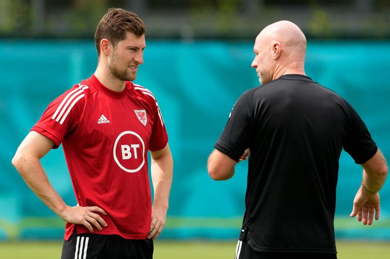 Wales defender Ben Davies, left, talks with Wales manager Robert Page. PA