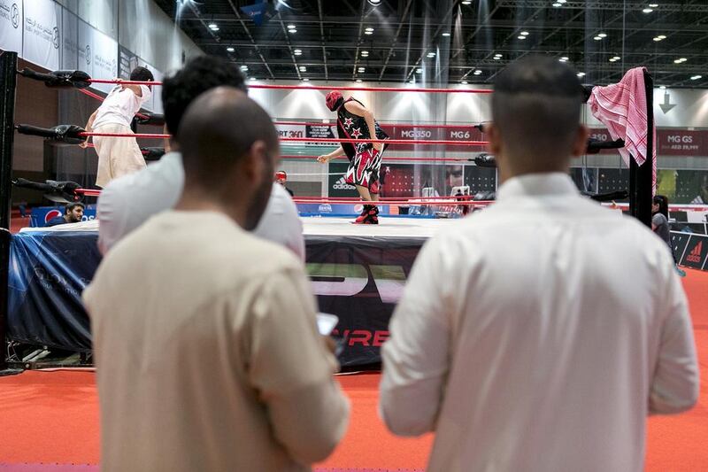 A pair of Emirati men watch a Dubai Pro Wrestling match. The weekly event at Dubai Sports World aims to become the premier wrestling promotion in the region. Reem Mohammed / The National