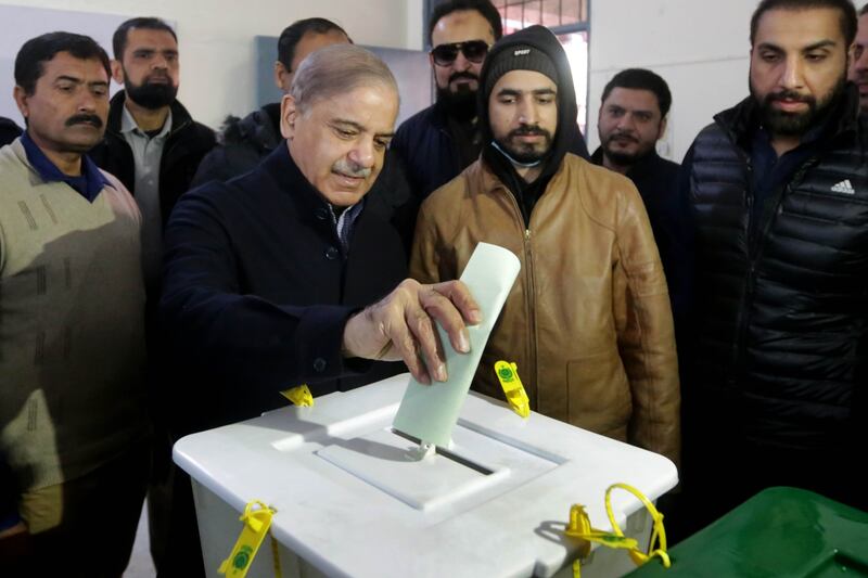 Shehbaz Sharif, centre, former prime minister and president of Pakistan Muslim League Nawaz casts his ballot in Lahore. EPA