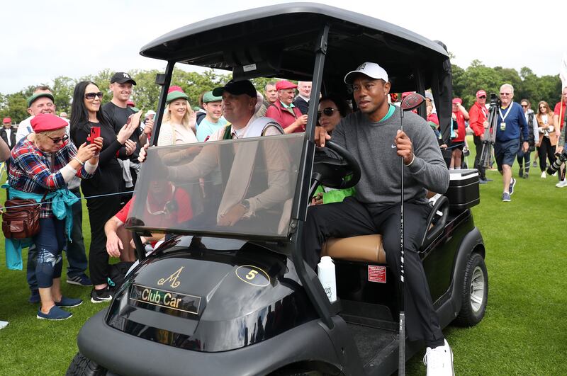 Tiger Woods drives a club car to his ball. Getty Images