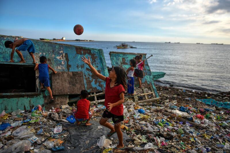 MANILA, PHILIPPINES - APRIL 14: Children playing on a beach filled with plastic wastes on April 14, 2018 in Manila, Philippines. The Philippines has been ranked third on the list of the world's top-five plastic polluter into the ocean, after China and Indonesia, while reports show that almost half of the global plastic garbage come from developing countries, including Vietnam and Thailand. Sunday marks the 48th iteration of Earth Day, an annual event marked across the world to show support for environmental protection, as organizations aim to dedicate this year's theme towards ending plastic pollution and change people's attitudes and behavior about plastic consumption and the impact it has on the environment. Over a million people have reportedly signed petitions around the world, demanding for corporations to reduce the production of single-use plastics which affects rapidly developing countries as most disposable packaging like food-wrapping, sachets, and shopping bags land up on the coastlines after being discarded. Most of these countries lack the infrastructure to effectively manage their waste and those who live on lower incomes usually rely on cheap products which are sold in single-use sachets such as instant coffee, shampoo, and food seasoning. According to studies, there could be more plastic in the sea than fish by 2050 while actual plastic bits might be in our seafood as fishes consume bits of plastic which are coated in bacteria and algae, mimicking their natural food sources, and eventually lands on our dinner table. (Photo by Jes Aznar/Getty Images)