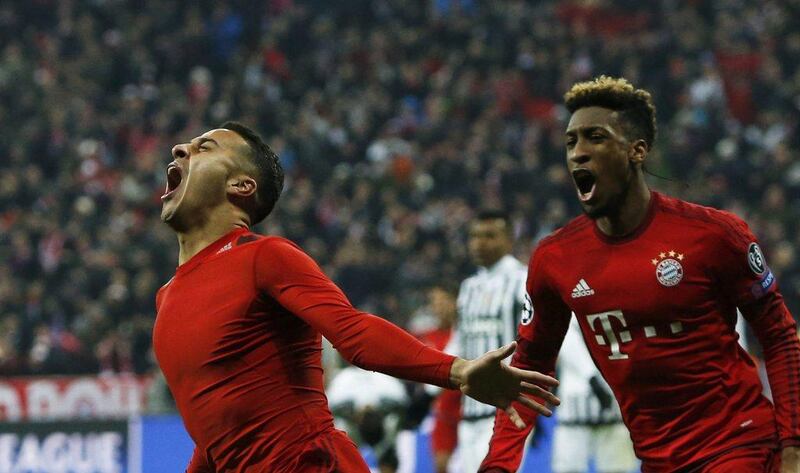 Bayern Munich’s Thiago Alcantara (L) celebrates after scoring a goal with Kingsley Coman. REUTERS/Michaela Rehle