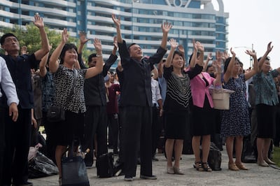 Residents react as they watch the televised annoucement on a big video screen on Mirae Scientists Street in Pyongyang that the country has successfully tested a hydrogen bomb on September 3, 2017.
North Korea declared itself a thermonuclear power on September 3, after carrying out a sixth nuclear test more powerful than any it has previously detonated, presenting President Donald Trump with a potent challenge. / AFP PHOTO / KIM Won-Jin