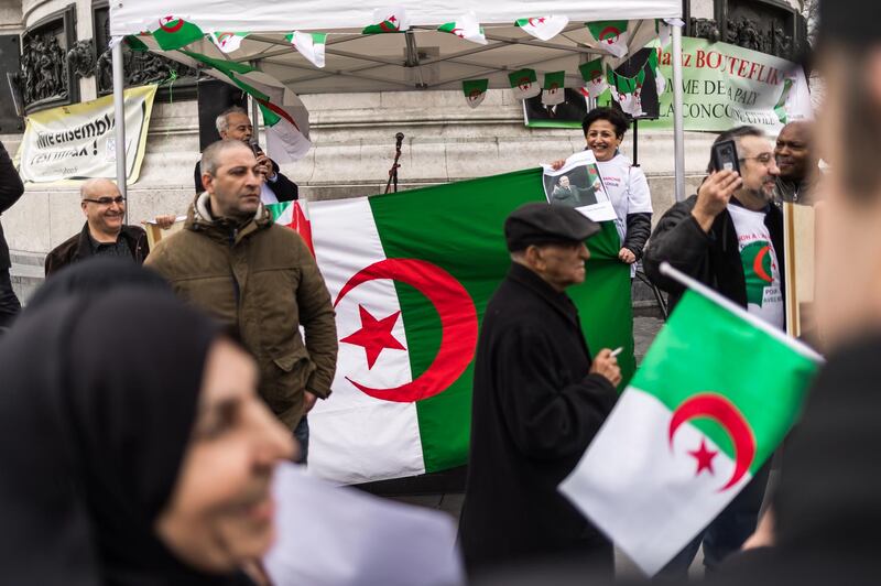 epa07408449 People hold posters of the Algerian president Abdelaziz Bouteflika as a group of Franco-Algerians gather at Republic square to support the fifth term of Bouteflika, in Paris, France, 02 March 2019. Abdelaziz Bouteflika, has been serving as the president since 1999, has announced on 19 February he will be running for a fifth term in presidential elections scheduled for 18 April 2019.  EPA/CHRISTOPHE PETIT TESSON