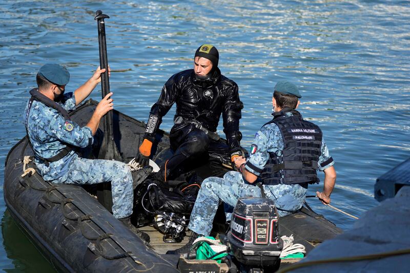 An Italian Navy diver and support team patrol the waters by the Arsenal complex of former shipyards and armories, where the G20 meeting is taking place.