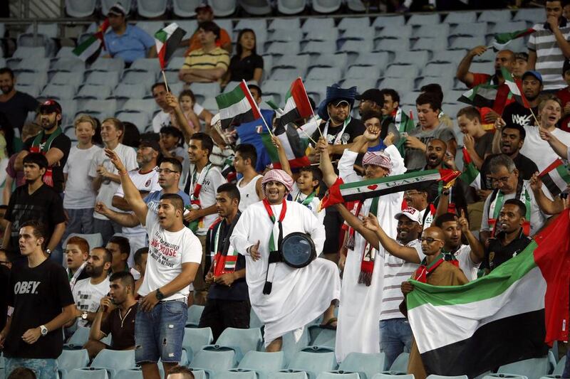 Drumming up support: Fahed Al Mansouri, centre, president of the UAE supporters club, leads the handful of cheering fans during the UAE’s shock win against Japan in the Asian Cup quarter-final at Stadium Australia in Sydney on Friday. Jason Reed / Reuters