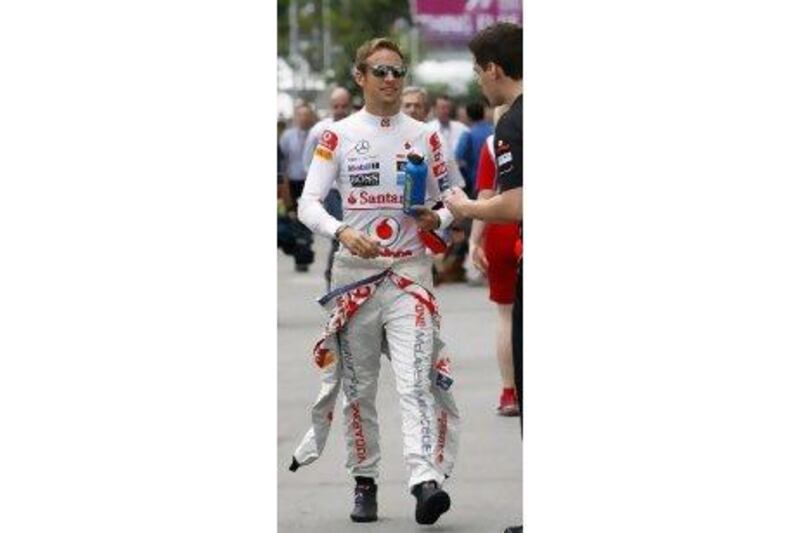 Jenson Button, in Singapore yesterday, is concerned by how long the race at Marina Bay Circuit lasts.