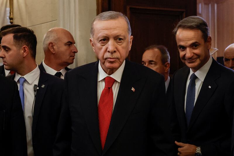 Mr Erdogan and Mr Mitsotakis arrive for a media briefing after their meeting. Reuters