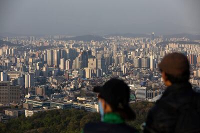 People look out at the city skyline from Mount Namsan in Seoul, South Korea, on Friday, April 24, 2020. South Korea reported six more coronavirus cases for the past 24 hours on Friday. New cases have slowed from a daily peak of more than 900 in late February. Photographer: SongJoon Cho/Bloomberg via Getty Images