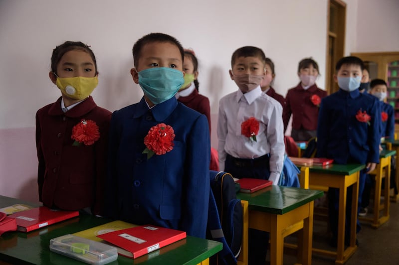 Primary school children wearing face masks as a protective measure against the COVID-19 novel coronavirus attend a class at Hasin Primary School in Sosong District in Pyongyang following the re-opening of schools on June 3, 2020. (Photo by KIM Won Jin / AFP)