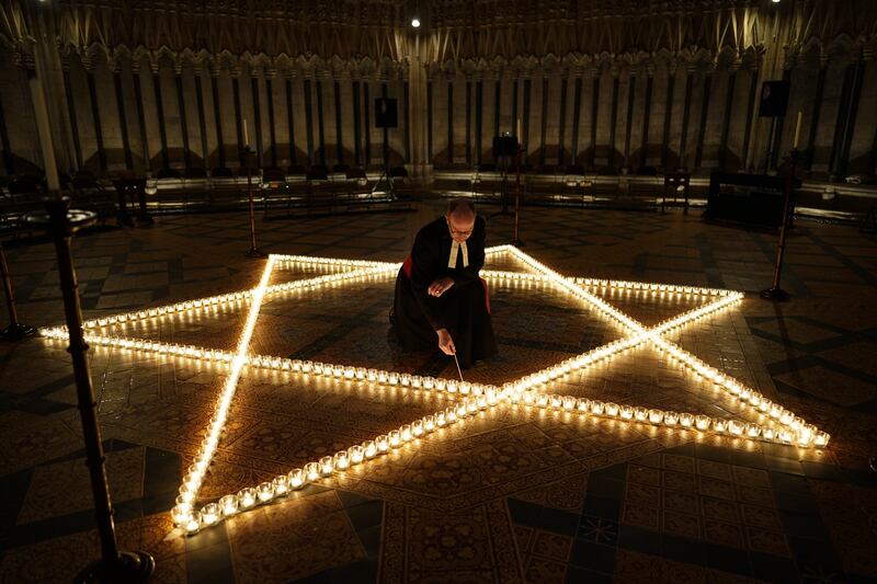 Reverend Canon Michael Smith, acting dean of York, lights candles in the shape of the Star of David in the Chapter House of York Minster for International Holocaust Remembrance Day. Getty