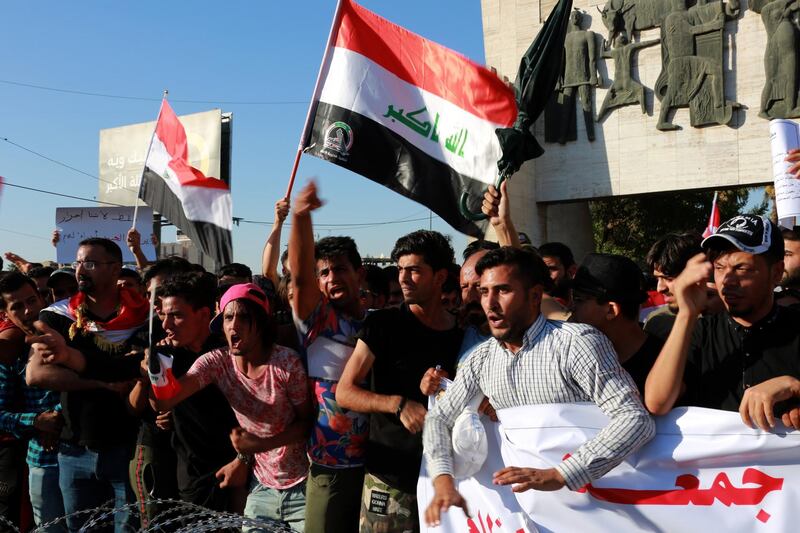 epa06901528 Iraqi protesters chant slogans during a demonstration at al-Tahrir square, central Baghdad, Iraq, 20 July 2018. According to media reports dozens of protesters were injured in the clashes that followed the demonstration by thousands of Iraqis over unemployment, the rising cost of living and lack of services in Baghdad, as the Iraqi government had deployed a significant amount of military and police forces in various provinces in southern Iraq and areas in Baghdad.  EPA/AHMED JALIL