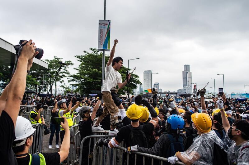 Pro-democracy lawmaker Roy Kwong chants slogans as protesters occupy outside Legislative Council. AFP