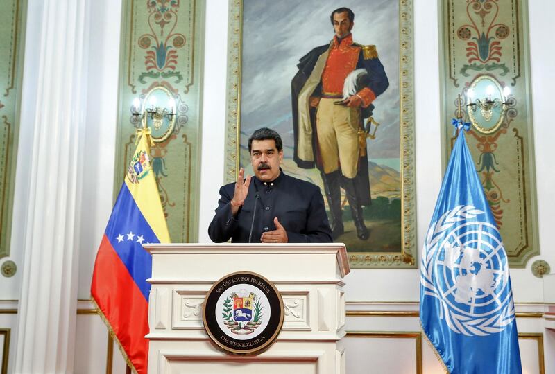 Venezuelan President Nicolas Maduro stands before a large portrait of 19th-century South American independence leader Simon Bolivar during his address. AFP/ Venezuela's Presidency