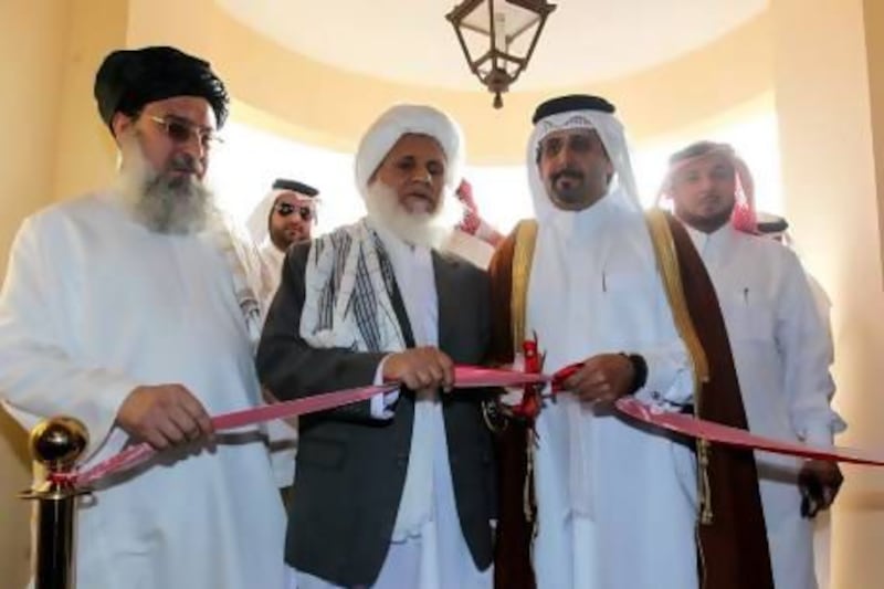 Qatari assistant foreign minister Ali bin Fahad Al Hajri (second from right) and the Taliban’s Jan Mohammad Madani cut the ribbon at the official opening ceremony of the Taliban Afghanistan Political Office, in Doha, Qatar.