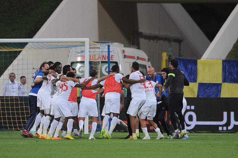 Al Jazira players and staff celebrate after defeating Al Dhafra on penalty kicks in their League Cup semi-final match on March 15, 2014. Courtesy Abdullateef Al Marzouqi / Al Ittihad