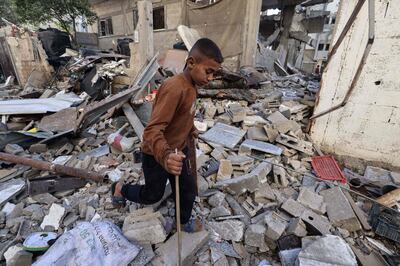 A boy walks amid the rubble of a building in Rafah on Monday after overnight Israeli bombardment. AFP 