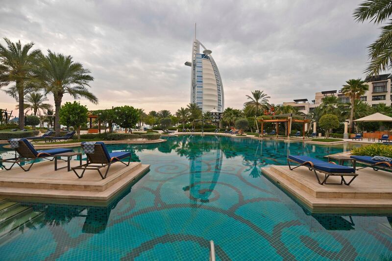 The Burj Al Arab hotel in Dubai as seen from the swimming pool of the Jumeirah al-Naseem hotel, as beaches open after coronavirus lockdown measures are eased in the emirate.  AFP