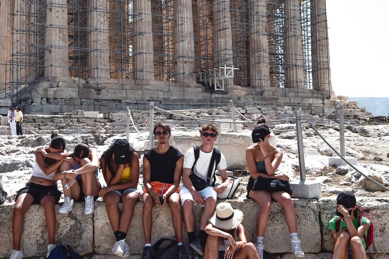 People struggle in the baking sun at the Acropolis in Athens