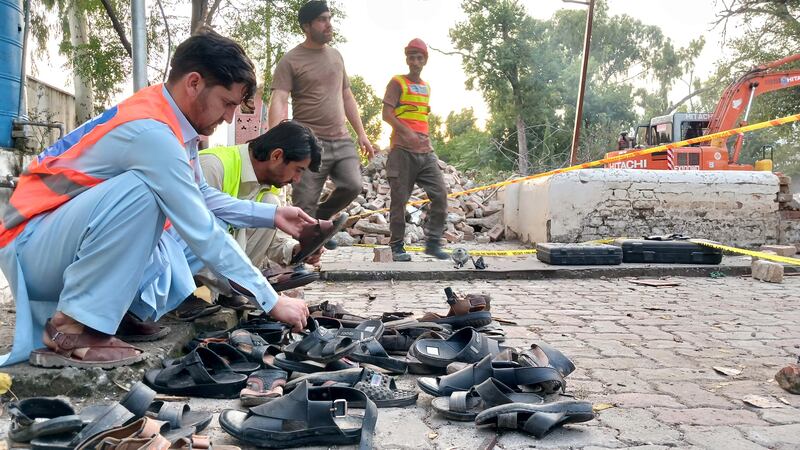 Investigators at the scene of the bomb attack, by two men, which brought down the roof of the mosque in Hangu, Khyber Pakhtunkhwa, Pakistan. EPA