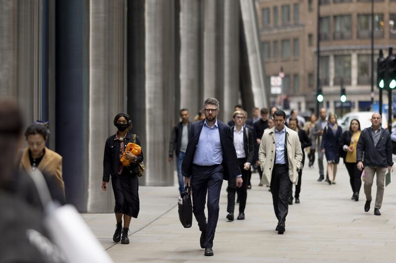People head to work in the City of London. Average UK salary increases are expected to fall in the private and public sectors this year. Bloomberg