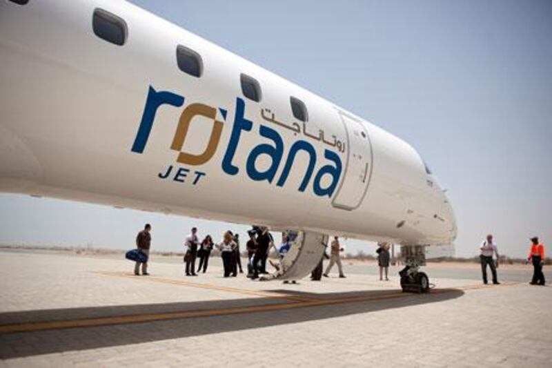Abu Dhabi, United Arab Emirates, Jun 5, 2012:   
People disembark the Rotana Jet on Tuesday, June 5, 2012, during the inaugural media flight to the Sir Bani Yas Island. Desert Islands Resort & Spa by Anantara have just announced their partnership with Rotana Jet to provide flights from Al Bateen Executive Airport  to Sir Bani Yas Island Seaport, which last about 30 minutes and will have a regular three-times-a-week schedule. (Silvia Razgova / The National)


