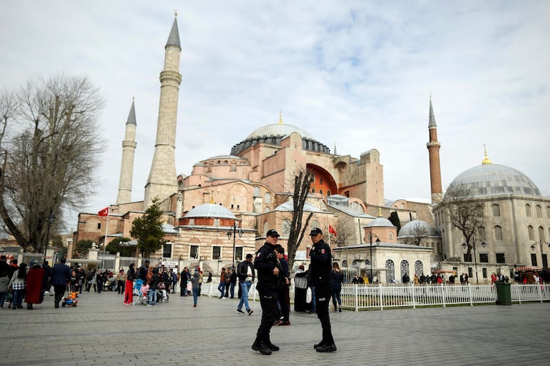 Turkish police secure the plaza in front of he Byzantine-era Hagia Sophia, one of Istanbul's main tourist attractions Hagia Sophia in Istanbul, Turkey, Friday, March 15, 2019. Turkey's President Recep Tayyip Erdogan says at least three Turkish citizens were injured in the attack that targeted Muslim worshippers in New Zealand and that he has spoken to one of them. (AP Photo/Emrah Gurel)
