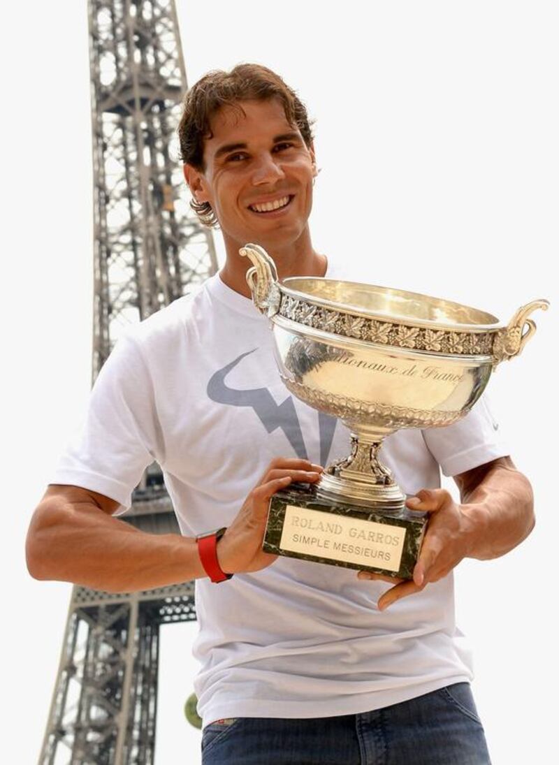 Rafael Nadal of Spain poses in front of the Eiffel Tower with his trophy after winning the French Open men's final at Roland Garros against Novak Djokovic of Serbia in Paris on June 9, 2014. Caroline Blumberg / EPA