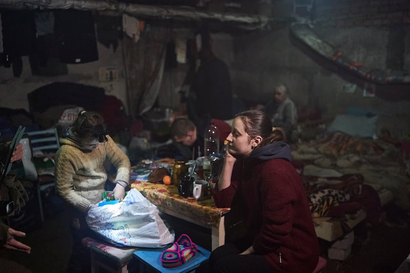 Anna and Nastya in the basement during a Russian attack nearby. AP