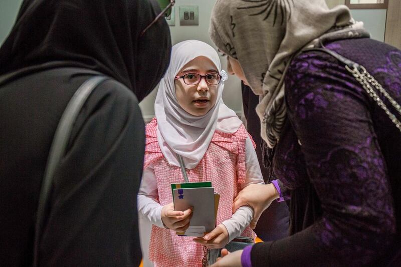 Mother and teacher talk to Aya Imad, 10, Grade 4, from Al Resalah International School of Science after her interview at the Arab Reading Challenge at the School of Research Science in Al Warqaa 4. Victor Besa for The National