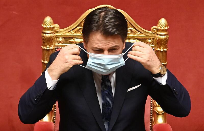 Italian Prime Minister Giuseppe Conte adjusts his face mask prior to an address at the Palazzo Madama in Rome, Italy. AFP