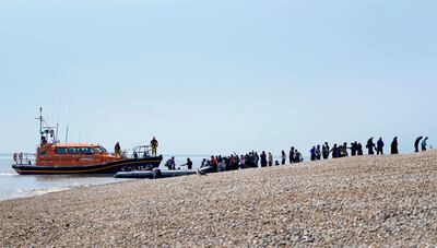 People thought to be migrants disembark from a RNLI boat in Kent, England. PA/AP