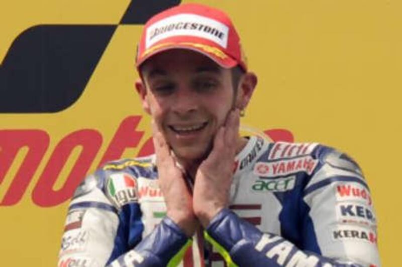 Italian rider Valentino Rossi of Fiat Yamaha Team smiles at the prize presentation after the Malaysian MotoGP.