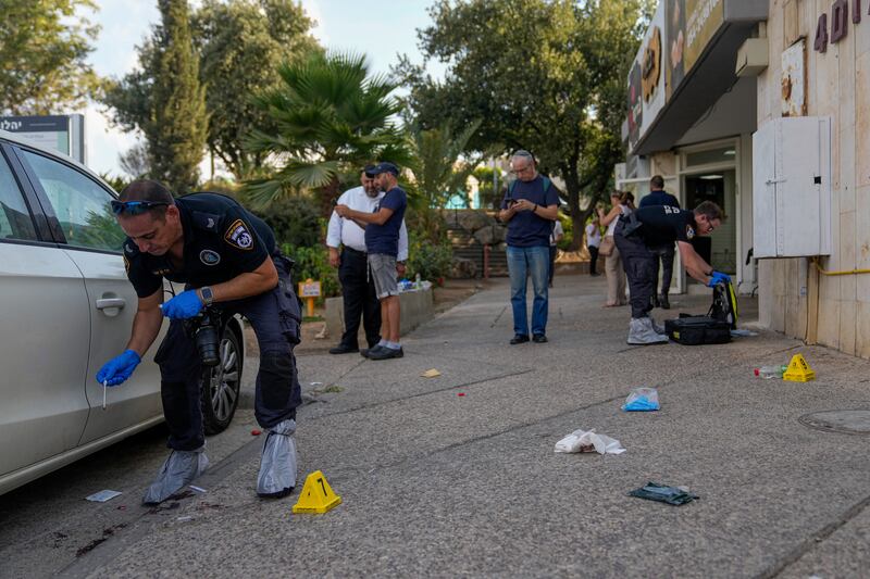 Israeli police inspect the site of a shooting attack in the West Bank Jewish settlement of Maale Adumim on Tuesday. AP
