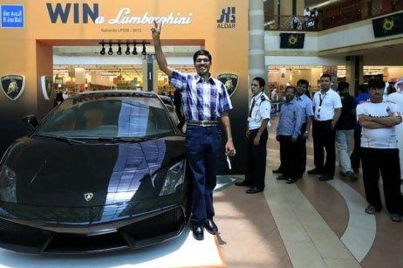 Soupi Abdulla with the Lamborghini he won in a raffle at the Al Jimi Mall in Al Ain.