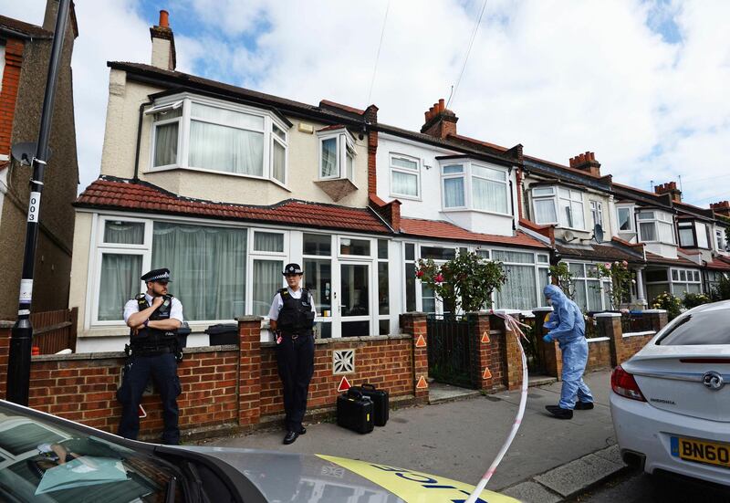 Police officers attend the scene where a women who was around eight months pregnant was stabbed to death, in Croydon, south London, England, Sunday June 30, 2019.  The woman, who has not yet been named by police, is understood to have died at the scene where her baby was delivered by paramedics, and is critically ill in hospital. (Kirsty O'Connor/PA via AP)