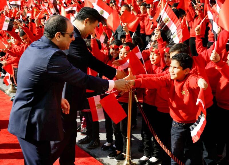 Egyptian president Abdel Fattah El Sisi and Chinese president Xi Jinping, shake hands with children at the Presidential Palace in Cairo on January 21, 2016. Mr Xi is on a two-day visit to the country - his first as Chinese president. Egyptian Presidency via AP