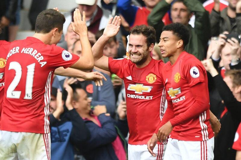 Manchester United midfielder Juan Mata, centre, is congratulated by his teammates after scoring against Leicester City at Old Trafford on Saturday, September 24, 2016. Anthony Delvin / AFP