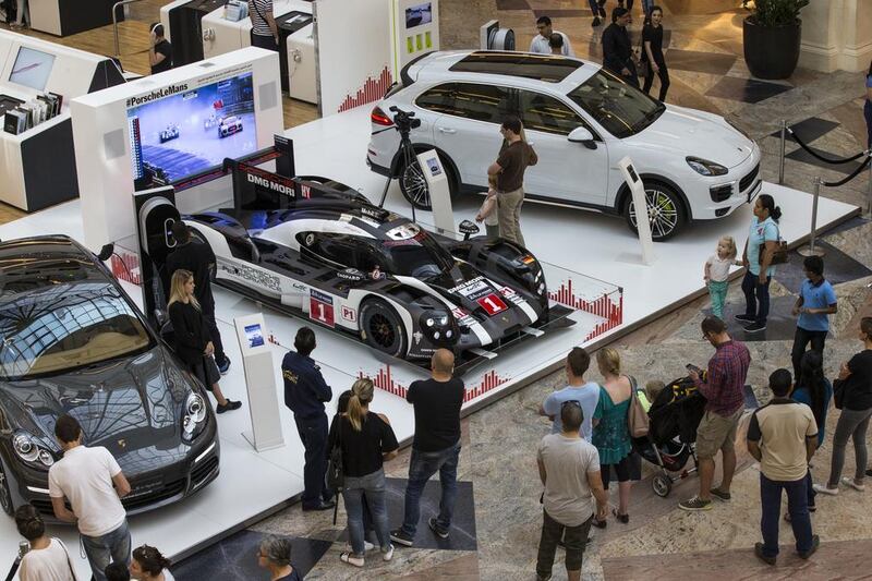 The Porsche 919 Hybrid, centre, which won at Le Mans 2016, flanked by the hybrid versions of the Panamera, left, and Cayenne, right. Courtesy Porsche