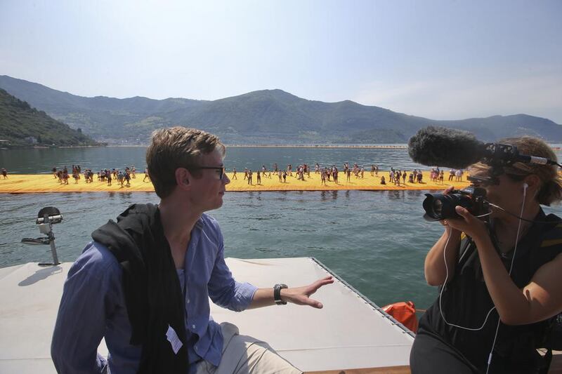 Frederik Jensen gives an interview on a boat sailing around the installation entitled The Floating Piers, created by Christo, at the Iseo Lake. Luca Bruno / AP photo